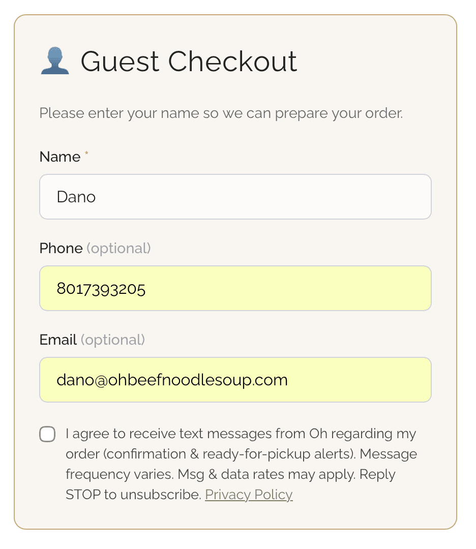 The SMS consent checkbox at guest checkout, unchecked by default